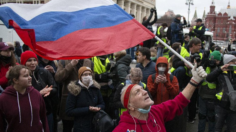 A woman argues with police officer during a protest in support of jailed opposition leader Alexei Navalny in Ulan-Ude, the regional capital of Buryatia, a region near the Russia-Mongolia border, Russia, Wednesday, April 21, 2021. Navalny's team has called for nationwide protests on Wednesday following reports that the politician's health was deteriorating in prison, where he has been on hunger strike since March 31. Russian authorities have stressed that the demonstrations were not authorized and warned against participating in them. (AP Photo/Anna Ogorodnik)