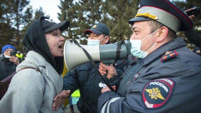 A woman argues with police officer during a protest in support of jailed opposition leader Alexei Navalny in Ulan-Ude, the regional capital of Buryatia, a region near the Russia-Mongolia border, Russia, Wednesday, April 21, 2021. Navalny's team has called for nationwide protests on Wednesday following reports that the politician's health was deteriorating in prison, where he has been on hunger strike since March 31. Russian authorities have stressed that the demonstrations were not authorized and warned against participating in them. (AP Photo/Anna Ogorodnik)