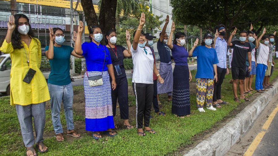 An anti-coup protester flashes the three-finger salute during a demonstration at Yangon, Myanmar on Wednesday, April 21, 2021. Aid workers and activists are warning Myanmar's political upheavals risk causing a regional refugee crisis as the strife following a February coup displaces growing numbers of people who have lost their livelihoods. (AP Photo)