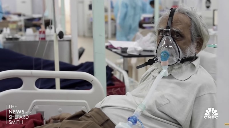 A COVID-19 patient wearing oxygen mask waits inside an auto rickshaw to be attended and admitted in a dedicated COVID-19 government hospital in Ahmedabad, India, Thursday, April 22, 2021. India reported a global record of more than 314,000 new infections Thursday as a grim coronavirus surge in the world's second-most populous country sends more and more sick people into a fragile health care system critically short of hospital beds and oxygen. (AP Photo/Ajit Solanki)