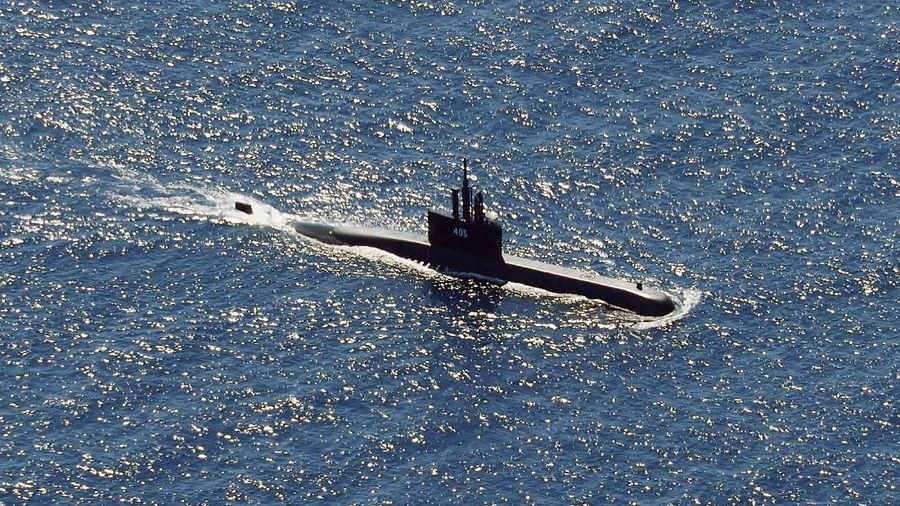 In this aerial photo taken from a maritime patrol aircraft of 800 Air Squadron of the 2nd Air Wing of Naval Aviation Center (PUSPENERBAL), the Indonesian Navy submarine KRI Alugoro sails during a search for KRI Nanggala, another submarine that went missing while participating in a training exercise on Wednesday, in the waters off Bali Island, Indonesia, Thursday, April 22, 2021. Indonesia's navy ships on Thursday were intensely searching for the submarine that likely fell too deep to retrieve, making survival chances for all the crew on board slim. Authorities said oxygen in the submarine would run out by early Saturday. (AP Photo/Eric Ireng)