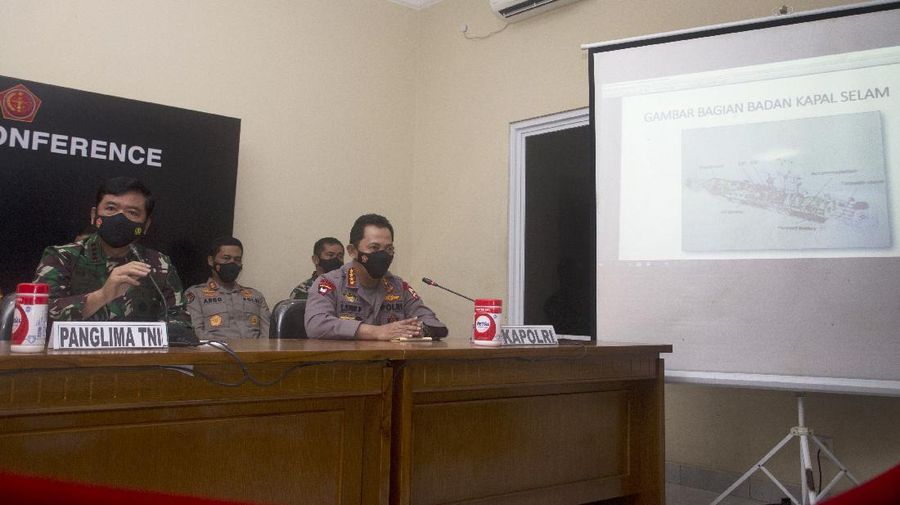 Indonesian Military chief Hadi Tjahjanto, left, shows an image of the Indonesian Navy submarine KRI Nanggala on a screen during a news conference at Ngurah Rai Military Air Base in Bali, Indonesia on Sunday, April 25, 2021. Indonesia’s military on Sunday officially admitted there was no hope of finding survivors from a submarine that sank and broke apart last week with 53 crew members aboard, and that search teams had located the vessel's wreckage on the ocean floor. (AP Photo/Firdia Lisnawati)