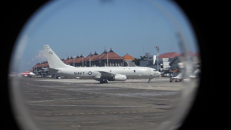 A U.S. Navy's P-8 Poseidon is parked on the tarmac at Ngurah Rai International Airport as seen from the window of Indonesian Navy's maritime patrol aircraft of 800 Air Squadron of the 2nd Air Wing of Naval Aviation Center (PUSPENERBAL), in Bali, Indonesia, Saturday, April 24, 2021. The American reconnaissance plane was expected to join the search for Indonesian navy submarine KRI Nanggala that went missing after its last reported dive Wednesday off the resort island. (AP Photo/Eric Ireng)