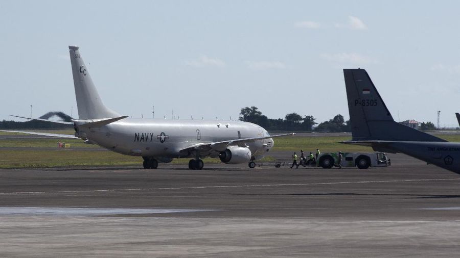 A U.S. Navy's P-8 Poseidon is parked on the tarmac at Ngurah Rai International Airport as seen from the window of Indonesian Navy's maritime patrol aircraft of 800 Air Squadron of the 2nd Air Wing of Naval Aviation Center (PUSPENERBAL), in Bali, Indonesia, Saturday, April 24, 2021. The American reconnaissance plane was expected to join the search for Indonesian navy submarine KRI Nanggala that went missing after its last reported dive Wednesday off the resort island. (AP Photo/Eric Ireng)