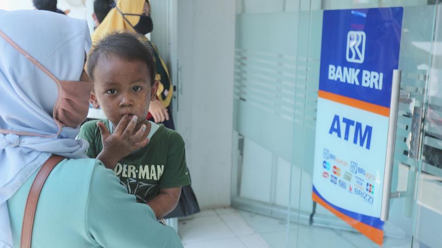 Sejumlah warga mendatangi Bank BRI di Jakarta untuk mendapatkan Banpres Produktif untuk Usaha Mikro (BPUM) sebesar 1,2 juta, Senin (26/4/2021). Program bernama Bantuan Produktif Usaha Mikro (BPUM) itu ditargetkan bisa menyalurkan ke 12,8 juta penerima selama tahun 2021. (CNBC Indonesia/ Tri Susilo)