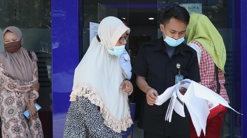 Sejumlah warga mendatangi Bank BRI di Jakarta untuk mendapatkan Banpres Produktif untuk Usaha Mikro (BPUM) sebesar 1,2 juta, Senin (26/4/2021). Program bernama Bantuan Produktif Usaha Mikro (BPUM) itu ditargetkan bisa menyalurkan ke 12,8 juta penerima selama tahun 2021. (CNBC Indonesia/ Tri Susilo)