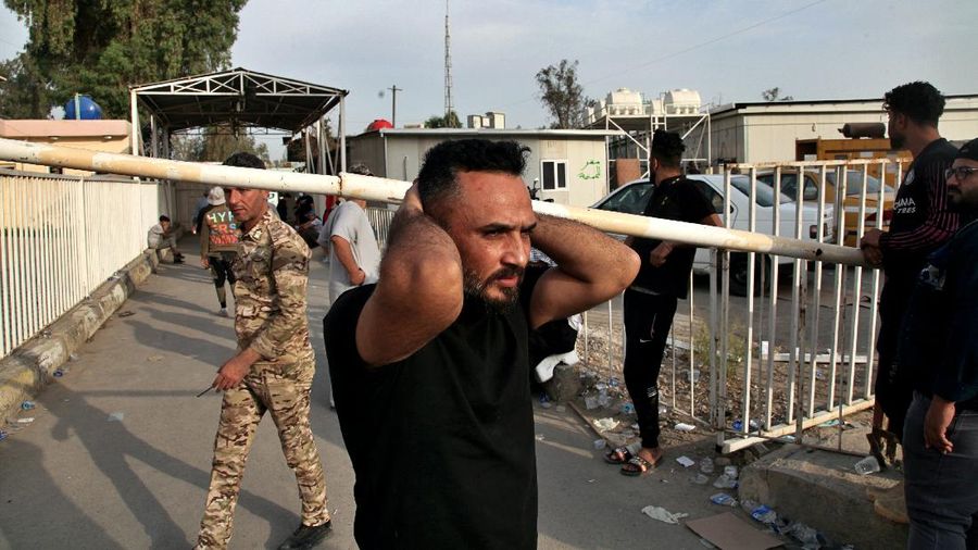 In this image made from video, first responders work the scene of a fire at a hospital in Baghdad on Saturday, April 24, 2021. The fire broke out in the Baghdad hospital that cares for coronavirus patients after oxygen cylinders reportedly exploded late Saturday, officials said. (AP Photo)