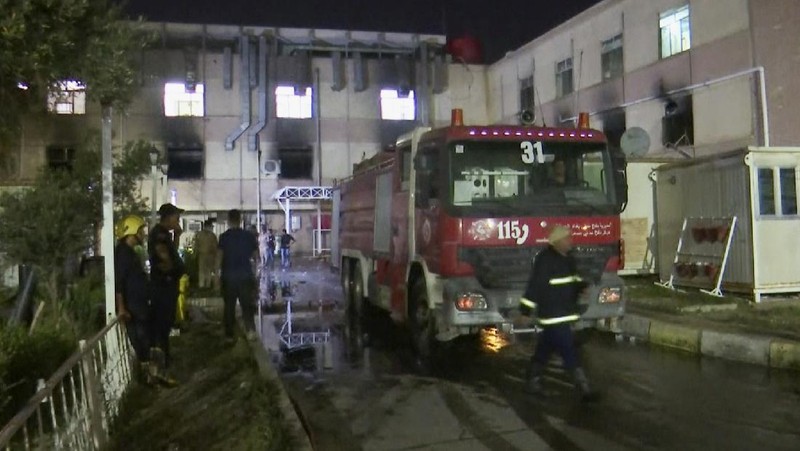 In this image made from video, first responders work the scene of a fire at a hospital in Baghdad on Saturday, April 24, 2021. The fire broke out in the Baghdad hospital that cares for coronavirus patients after oxygen cylinders reportedly exploded late Saturday, officials said. (AP Photo)
