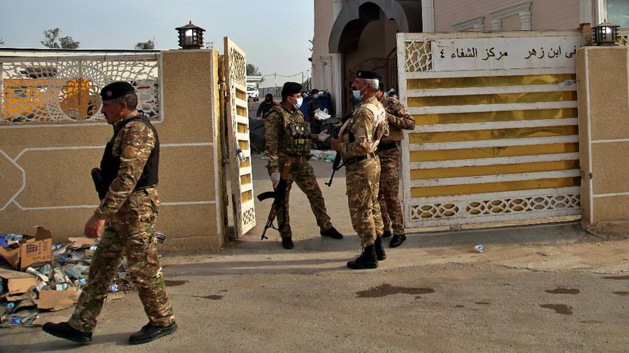 In this image made from video, first responders work the scene of a fire at a hospital in Baghdad on Saturday, April 24, 2021. The fire broke out in the Baghdad hospital that cares for coronavirus patients after oxygen cylinders reportedly exploded late Saturday, officials said. (AP Photo)