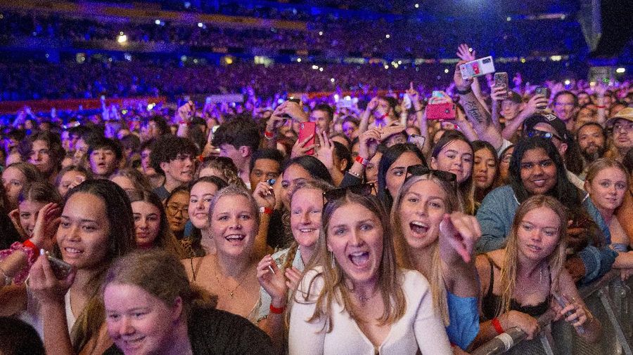 Fans watch the New Zealand band Six60 perform at Eden Park in Auckland, New Zealand, Saturday, April 24, 2021. Six60 is being billed as the biggest live act in the world since the coronavirus pandemic struck after New Zealand stamped out the spread of the virus, allowing life to return to normal. On Saturday, the band played a remarkable finale to their latest tour, performing in front of 50,000 people at the first-ever concert at Auckland's Eden Park.(AP Photo/David Rowland)