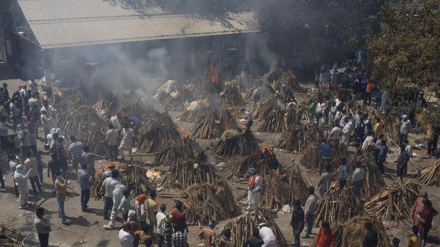 Multiple funeral pyres of those who died of COVID-19 burn at a ground that has been converted into a crematorium for the mass cremation of coronavirus victims, in New Delhi, India, Saturday, April 24, 2021. Delhi has been cremating so many bodies of coronavirus victims that authorities are getting requests to start cutting down trees in city parks, as a second record surge has brought India's tattered healthcare system to its knees. (AP Photo/Altaf Qadri)