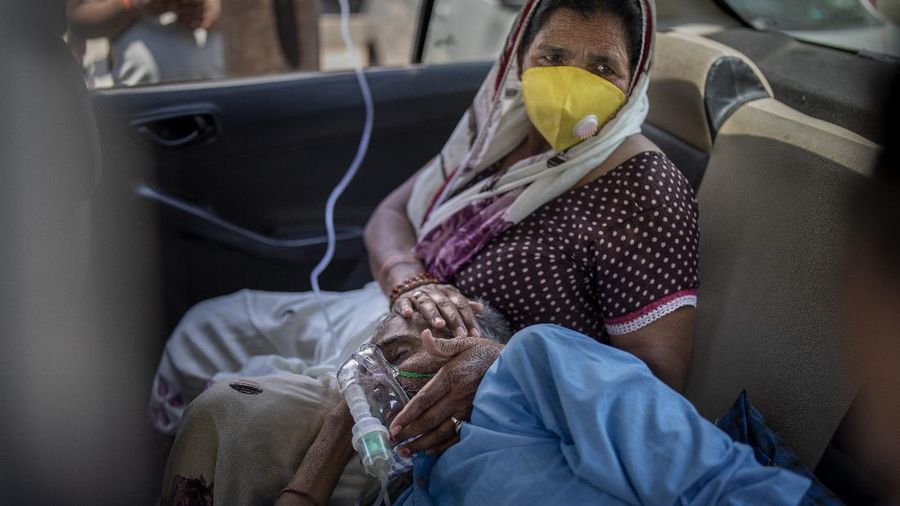 A patient breathes with the help of oxygen provided by a Gurdwara, Sikh place of worship, inside a car in New Delhi, India, Saturday, April 24, 2021. India’s medical oxygen shortage has become so dire that this gurdwara began offering free breathing sessions with shared tanks to COVID-19 patients waiting for a hospital bed. They arrive in their cars, on foot or in three-wheeled taxis, desperate for a mask and tube attached to the precious oxygen tanks outside the gurdwara in a neighborhood outside New Delhi. (AP Photo/Altaf Qadri)