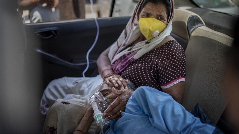 A relative of a person who died of COVID-19 breaks down during cremation in Jammu, India, Sunday, April 25, 2021. India’s crematoriums and burial grounds are being overwhelmed by the devastating new surge of infections tearing through the populous country with terrifying speed, depleting the supply of life-saving oxygen to critical levels and leaving patients to die while waiting in line to see doctors. (AP Photo/Channi Anand)