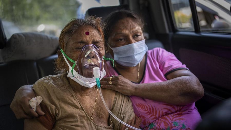 A relative of a person who died of COVID-19 breaks down during cremation in Jammu, India, Sunday, April 25, 2021. India’s crematoriums and burial grounds are being overwhelmed by the devastating new surge of infections tearing through the populous country with terrifying speed, depleting the supply of life-saving oxygen to critical levels and leaving patients to die while waiting in line to see doctors. (AP Photo/Channi Anand)