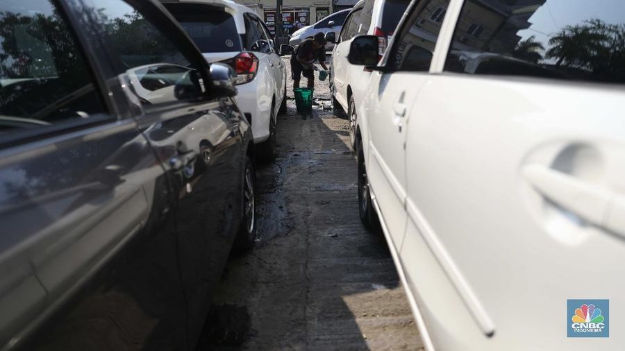 Pekerja membersihkan mobil rental yang terparkir di kawasan Tanjung Priok, Jakarta, Selasa, (27/4). Salah satu pemilik jasa rental mobil rentcartopiq Taufiq mengatakan, musim mudik di bulan ramadhan ini masih sepi order. 