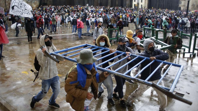 Protesters, one with a sign that reads in Spanish 