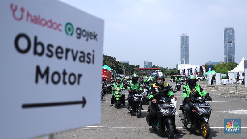 Petugas kesehatan menyuntikkan vaksin dosis pertama kepada driver Gojek di Kemayoran, Jakarta, Kamis (29/4/2021). Halodoc dan Gojek berkolaborasi hadirkan pos pelayanan Covid-19 melalui metode Drive thru dan melayani 1.500 dosis vaksin setiap harinya untuk memperkuat upaya Kementerian Kesehatan RI dalam mempercepat Vaksinasi Covid-19 di Indonesia.  (CNBC Indonesia/ Tri Susilo)