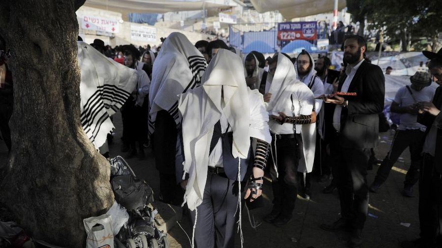 Israeli security officials and rescuers carry a body of a victim who died during a Lag Ba'Omer celebrations at Mt. Meron in northern Israel, Friday, April 30, 2021. More than 100 people were injured, dozens critically, in a stampede at a Jewish religious gathering in northern Israel attended by tens of thousands of people, Israel's main rescue service said early Friday. (AP Photo)