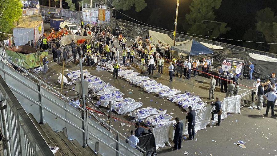 Israeli security officials and rescuers carry a body of a victim who died during a Lag Ba'Omer celebrations at Mt. Meron in northern Israel, Friday, April 30, 2021. More than 100 people were injured, dozens critically, in a stampede at a Jewish religious gathering in northern Israel attended by tens of thousands of people, Israel's main rescue service said early Friday. (AP Photo)
