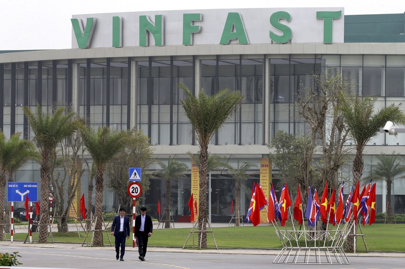 VinFas Two men walk outside the main entrance of VinFast, an automotive startup manufacturer in Hai Phong, Vietnam Wednesday, Feb. 27, 2019. As North Korean leader Kim Jong Un prepared for his second summit with President Donald Trump, top members of his delegation made a whirlwind tour of one of Vietnam’s most successful conglomerates. (AP Photo/Minh Hoang)
