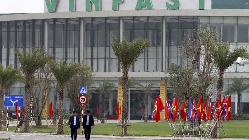 Two men walk outside the main entrance of VinFast, an automotive startup manufacturer in Hai Phong, Vietnam Wednesday, Feb. 27, 2019. As North Korean leader Kim Jong Un prepared for his second summit with President Donald Trump, top members of his delegation made a whirlwind tour of one of Vietnam’s most successful conglomerates. (AP Photo/Minh Hoang)