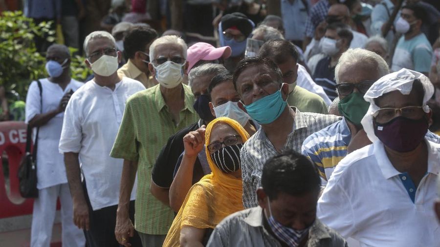 People queue up for COVID-19 vaccine in Mumbai, India, Monday, April 26, 2021. New infections are rising faster in India than any other place in the world, stunning authorities and capsizing its fragile health system. (AP Photo/Rafiq Maqbool)
