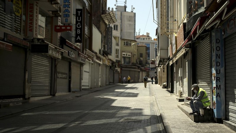 A man walks on deserted Eminonu market with shops closed, Friday, April 30, 2021, on the first day of a tight lockdown to help protect from the spread of the coronavirus. Turkish President Recep Tayyip Erdogan imposed the new lockdown restrictions that will last until May 17, after COVID-19 infections and fatalities hit record high levels. Under the restrictions -- which spans the holy Muslim month of Ramadan, as well as the three-day Eid holiday - residents are banned from leaving their homes except to shop for groceries or to meet other essential needs.(AP Photo/Emrah Gurel)