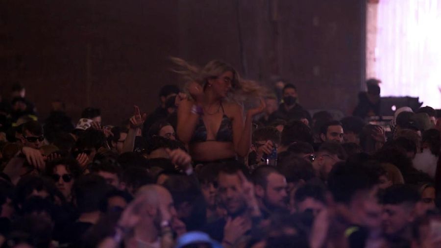 Revellers at the Circus Nightclub at Bramley-Moore Dock, in Liverpool, England, Friday, April 30, 2021. Several thousand music fans have become the first people in Britain in more than a year to legally dance, drink and listen to music in a nightclub. A gig at a warehouse in Liverpool, England that started on Friday afternoon is one of a series of pilot events sponsored by the government and closely monitored by public health officials. The 3,000 attendee, will be tested for the virus before and after the event. (Richard McCarthy/PA via AP)