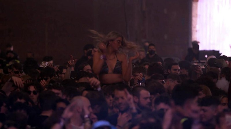 Revellers at the Circus Nightclub at Bramley-Moore Dock, in Liverpool, England, Friday, April 30, 2021. Several thousand music fans have become the first people in Britain in more than a year to legally dance, drink and listen to music in a nightclub. A gig at a warehouse in Liverpool, England that started on Friday afternoon is one of a series of pilot events sponsored by the government and closely monitored by public health officials. The 3,000 attendee, will be tested for the virus before and after the event. (Richard McCarthy/PA via AP)