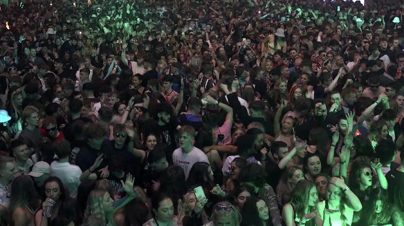 Revellers at the Circus Nightclub at Bramley-Moore Dock, in Liverpool, England, Friday, April 30, 2021. Several thousand music fans have become the first people in Britain in more than a year to legally dance, drink and listen to music in a nightclub. A gig at a warehouse in Liverpool, England that started on Friday afternoon is one of a series of pilot events sponsored by the government and closely monitored by public health officials. The 3,000 attendee, will be tested for the virus before and after the event. (Richard McCarthy/PA via AP)