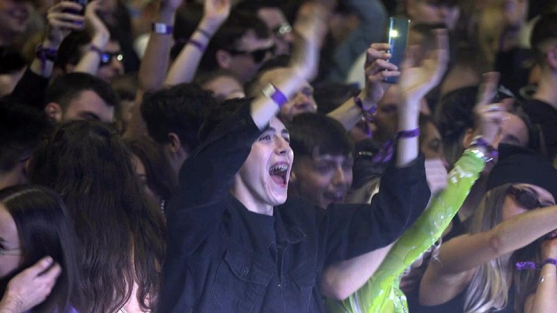 Revellers at the Circus Nightclub at Bramley-Moore Dock, in Liverpool, England, Friday, April 30, 2021. Several thousand music fans have become the first people in Britain in more than a year to legally dance, drink and listen to music in a nightclub. A gig at a warehouse in Liverpool, England that started on Friday afternoon is one of a series of pilot events sponsored by the government and closely monitored by public health officials. The 3,000 attendee, will be tested for the virus before and after the event. (Richard McCarthy/PA via AP)