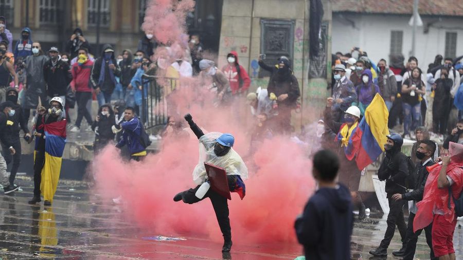 Bentrokan terjadi antara massa aksi protes reformasi pajak dengan aparat keamanan di Kolombia. (AP/Fernando Vergara)