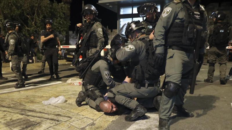Israeli border police officers detain a Palestinian demonstrator during clashes with Palestinian protesters, in east Jerusalem, Friday, May 7. 2021. Palestinians protested over Israel's threatened eviction of dozens of Palestinians in the Sheikh Jarrah neighborhood in east Jerusalem, who have been embroiled in a long legal battle with Israeli settlers trying to acquire property in the neighborhood. (AP Photo/Mahmoud Illean)