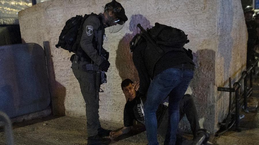 Israeli border police officers detain a Palestinian demonstrator during clashes with Palestinian protesters, in east Jerusalem, Friday, May 7. 2021. Palestinians protested over Israel's threatened eviction of dozens of Palestinians in the Sheikh Jarrah neighborhood in east Jerusalem, who have been embroiled in a long legal battle with Israeli settlers trying to acquire property in the neighborhood. (AP Photo/Mahmoud Illean)