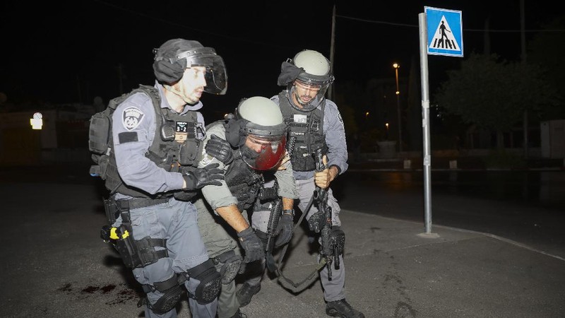 Israeli border police officers detain a Palestinian demonstrator during clashes with Palestinian protesters, in east Jerusalem, Friday, May 7. 2021. Palestinians protested over Israel's threatened eviction of dozens of Palestinians in the Sheikh Jarrah neighborhood in east Jerusalem, who have been embroiled in a long legal battle with Israeli settlers trying to acquire property in the neighborhood. (AP Photo/Mahmoud Illean)