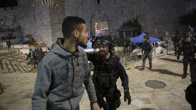 Israeli border police officers detain a Palestinian demonstrator during clashes with Palestinian protesters, in east Jerusalem, Friday, May 7. 2021. Palestinians protested over Israel's threatened eviction of dozens of Palestinians in the Sheikh Jarrah neighborhood in east Jerusalem, who have been embroiled in a long legal battle with Israeli settlers trying to acquire property in the neighborhood. (AP Photo/Mahmoud Illean)
