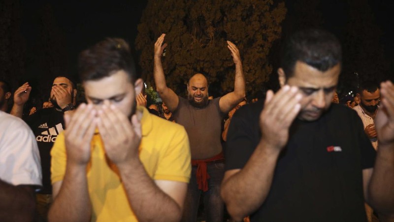 Palestinian Muslim worshippers pray during the Laylat al-Qadr, or the night of destiny, in the holy fasting month of Ramadan, in front of the Dome of the Rock Mosque at the Al Aqsa Mosque compound in Jerusalem's Old City Saturday, May 8, 2021. (AP Photo/Mahmoud Illean)
