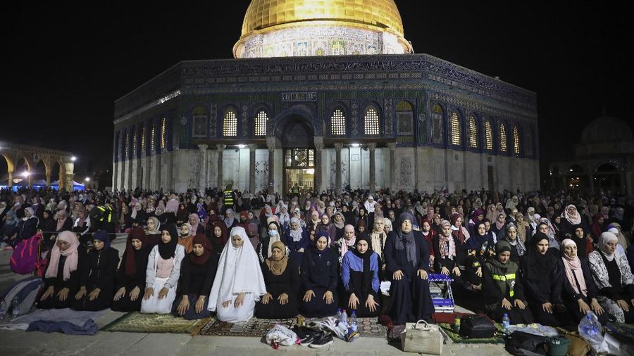 Palestinian Muslim worshippers pray during the Laylat al-Qadr, or the night of destiny, in the holy fasting month of Ramadan, in front of the Dome of the Rock Mosque at the Al Aqsa Mosque compound in Jerusalem's Old City Saturday, May 8, 2021. (AP Photo/Mahmoud Illean)