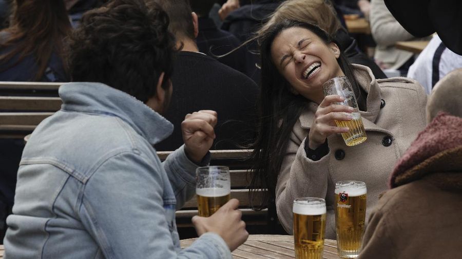People enjoy drinks at an outdoor cafe in the center of Brussels, Saturday, May 8, 2021. Amid encouraging signs that the latest COVID-19 surge is on the wane, Belgians were celebrating a series of relaxation measures Saturday, including bars and restaurants being allowed to open their terraces again to customers. (AP Photo/Olivier Matthys)