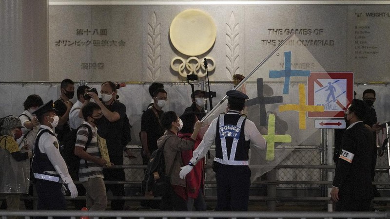 People who are against the Tokyo 2020 Olympics set to open in July, march to protest around Tokyo's National Stadium during an anti-Olympics demonstration Sunday, May 9, 2021. (AP Photo/Eugene Hoshiko)