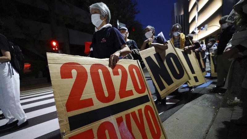 People who are against the Tokyo 2020 Olympics set to open in July, march to protest around Tokyo's National Stadium during an anti-Olympics demonstration Sunday, May 9, 2021. (AP Photo/Eugene Hoshiko)