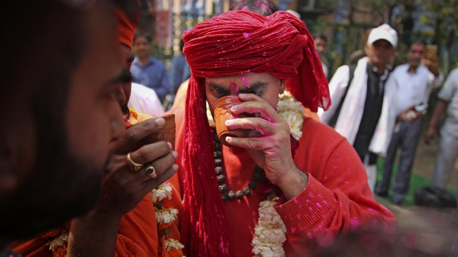 National president of Akhil Bhartiya Hindu Mahasabha Swami Chakrapani Maharaj drinks cow urine during an event organized by a Hindu religious group to promote consumption of cow urine as a cure for the new coronavirus in New Delhi, India, Saturday, March 14, 2020. The vast majority of people recover from the new coronavirus. According to the World Health Organization, people with mild illness recover in about two weeks, while those with more severe illness may take three to six weeks to recover. (AP Photo/Altaf Qadri)