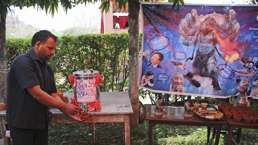 National president of Akhil Bhartiya Hindu Mahasabha Swami Chakrapani Maharaj drinks cow urine during an event organized by a Hindu religious group to promote consumption of cow urine as a cure for the new coronavirus in New Delhi, India, Saturday, March 14, 2020. The vast majority of people recover from the new coronavirus. According to the World Health Organization, people with mild illness recover in about two weeks, while those with more severe illness may take three to six weeks to recover. (AP Photo/Altaf Qadri)
