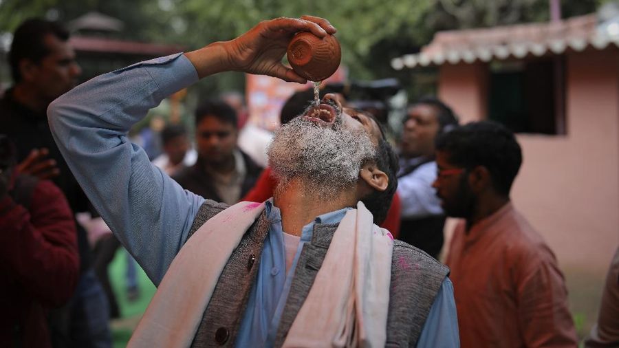 National president of Akhil Bhartiya Hindu Mahasabha Swami Chakrapani Maharaj drinks cow urine during an event organized by a Hindu religious group to promote consumption of cow urine as a cure for the new coronavirus in New Delhi, India, Saturday, March 14, 2020. The vast majority of people recover from the new coronavirus. According to the World Health Organization, people with mild illness recover in about two weeks, while those with more severe illness may take three to six weeks to recover. (AP Photo/Altaf Qadri)