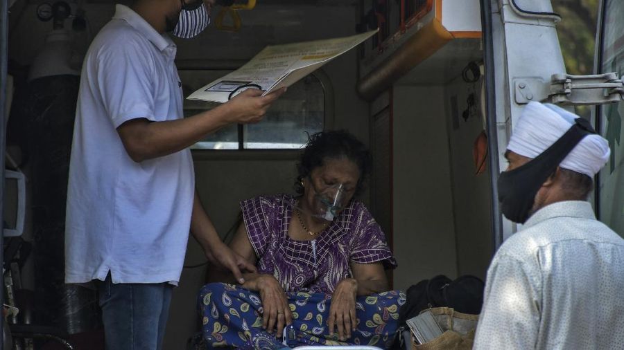 Susheela Singh, 72, whose oxygen level is low waits inside an ambulance outside a COVID-19 hospital that was set up at a Sikh Gurdwara in New Delhi, India, Monday, May 10, 2021. She was referred to a bigger hospital in the city. (AP Photo/Ishant Chauhan)