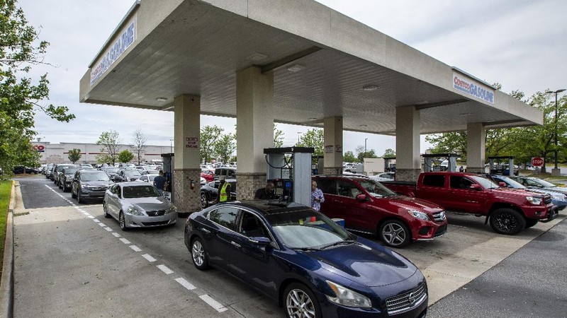 Customers fill up their automobiles and gas containers with fuel at the Circle K on Wednesday, May 12, 2021 in Raleigh, N.C.  Several gas stations in the Southeast reported running out of fuel, primarily because of what analysts say is unwarranted panic-buying among drivers, as the shutdown of a major pipeline by hackers entered its fifth day.  (Robert Willett/The News & Observer via AP)