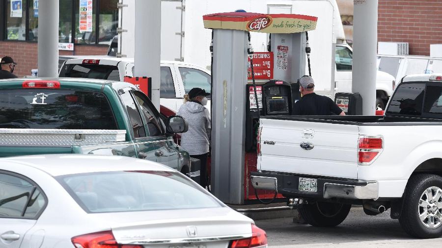 Customers fill up their automobiles and gas containers with fuel at the Circle K on Wednesday, May 12, 2021 in Raleigh, N.C.  Several gas stations in the Southeast reported running out of fuel, primarily because of what analysts say is unwarranted panic-buying among drivers, as the shutdown of a major pipeline by hackers entered its fifth day.  (Robert Willett/The News & Observer via AP)