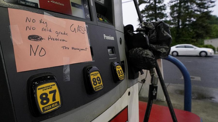 Customers fill up their automobiles and gas containers with fuel at the Circle K on Wednesday, May 12, 2021 in Raleigh, N.C.  Several gas stations in the Southeast reported running out of fuel, primarily because of what analysts say is unwarranted panic-buying among drivers, as the shutdown of a major pipeline by hackers entered its fifth day.  (Robert Willett/The News & Observer via AP)