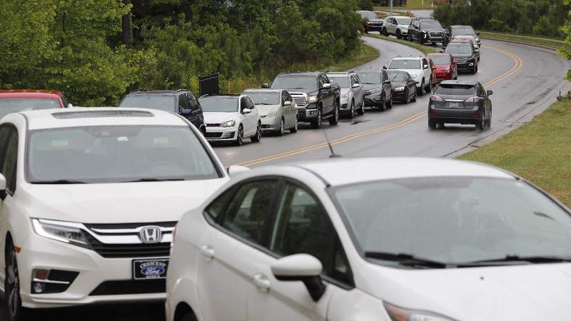 Customers fill up their automobiles and gas containers with fuel at the Circle K on Wednesday, May 12, 2021 in Raleigh, N.C.  Several gas stations in the Southeast reported running out of fuel, primarily because of what analysts say is unwarranted panic-buying among drivers, as the shutdown of a major pipeline by hackers entered its fifth day.  (Robert Willett/The News & Observer via AP)