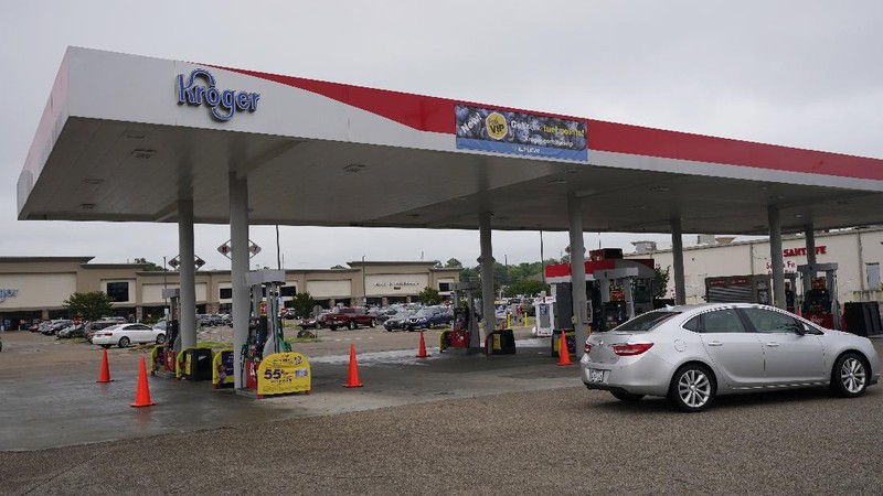 Customers fill up their automobiles and gas containers with fuel at the Circle K on Wednesday, May 12, 2021 in Raleigh, N.C.  Several gas stations in the Southeast reported running out of fuel, primarily because of what analysts say is unwarranted panic-buying among drivers, as the shutdown of a major pipeline by hackers entered its fifth day.  (Robert Willett/The News & Observer via AP)